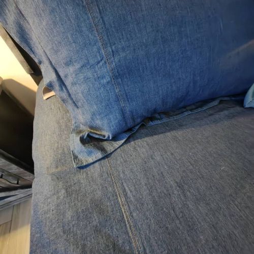 Close-up of blue denim fabric with a pocket detail.