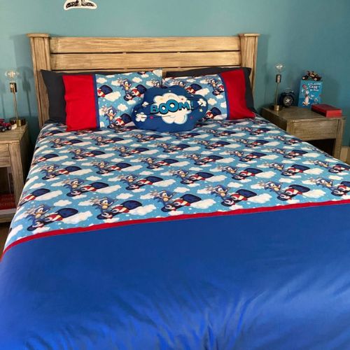 Bedding set with cartoon design featuring a 'BOOM!' graphic on a blue comforter.