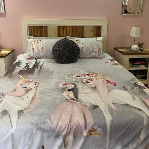 Bed with unicorn-themed bedding in a bedroom setting