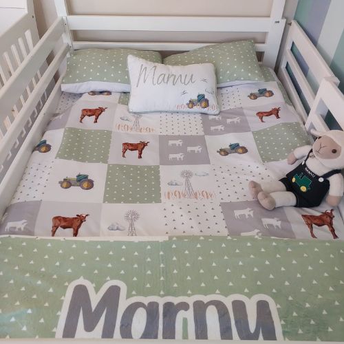 Children's bed with farm-themed bedding and 'Marmy' pillow