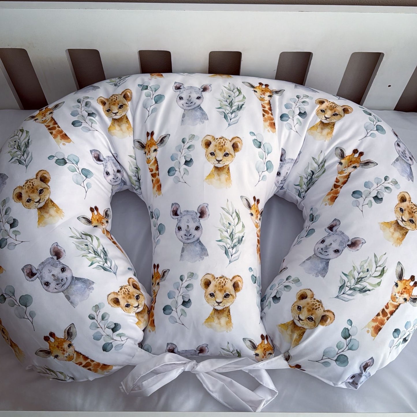 Breast feeding pillow with animal pattern in a crib