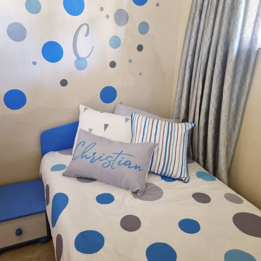 Children's bedroom with polka dot bedding and wall stickers.