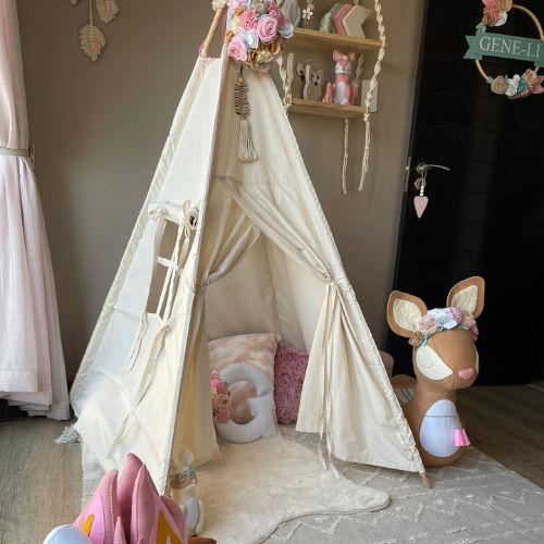 Children's playroom with a teepee, stuffed animal, and decorative elements.