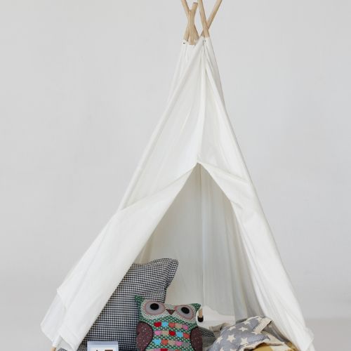 White children's teepee with stuffed animals and cushions on a plain background