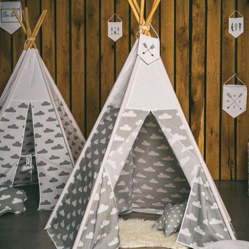Children's teepee with cloud pattern against a wooden wall