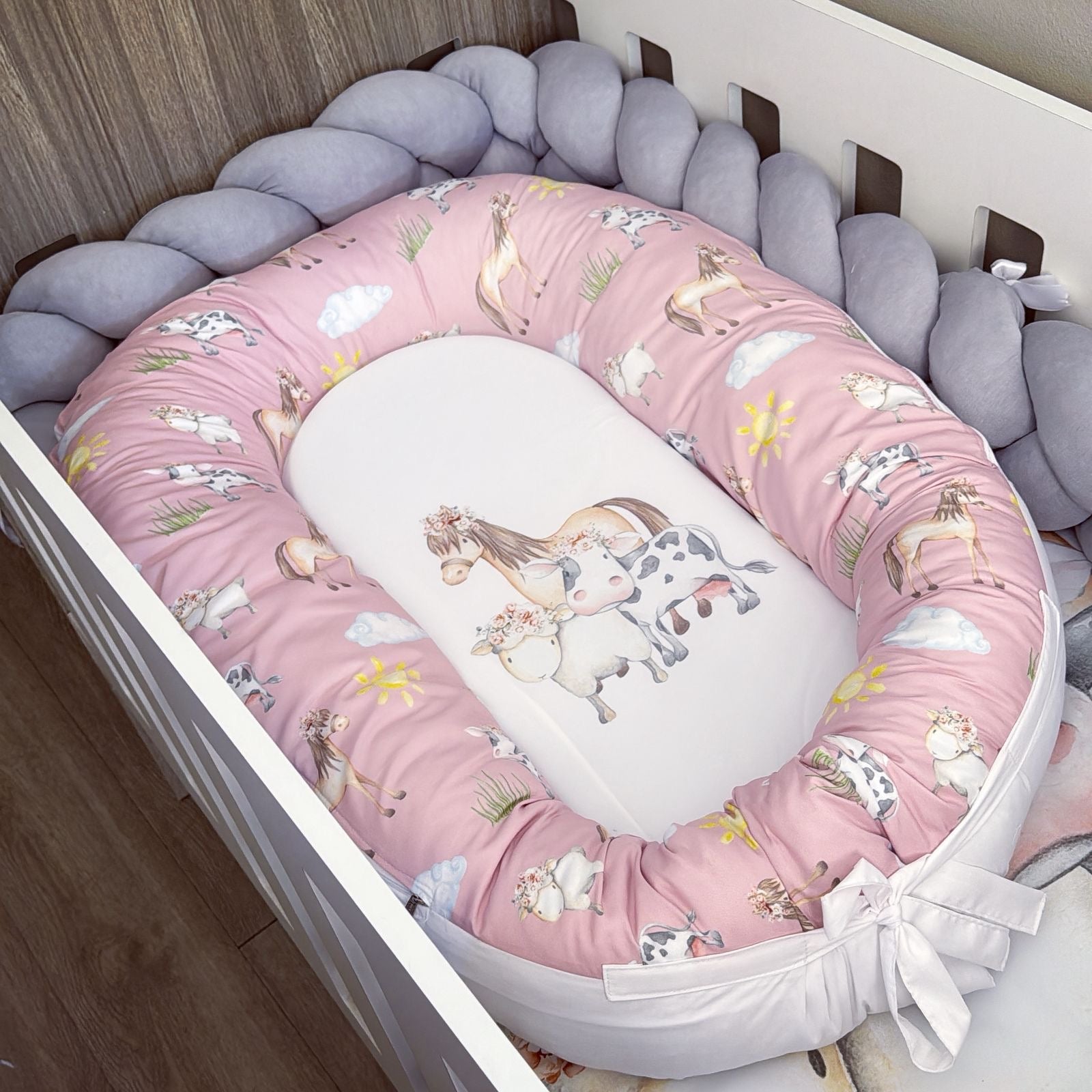 Baby crib bumper with farm design in a crib