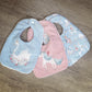 Three baby bibs with animal designs on a wooden surface | Baby Essentials | All Baby Products | Soft Spot Kids | South Africa