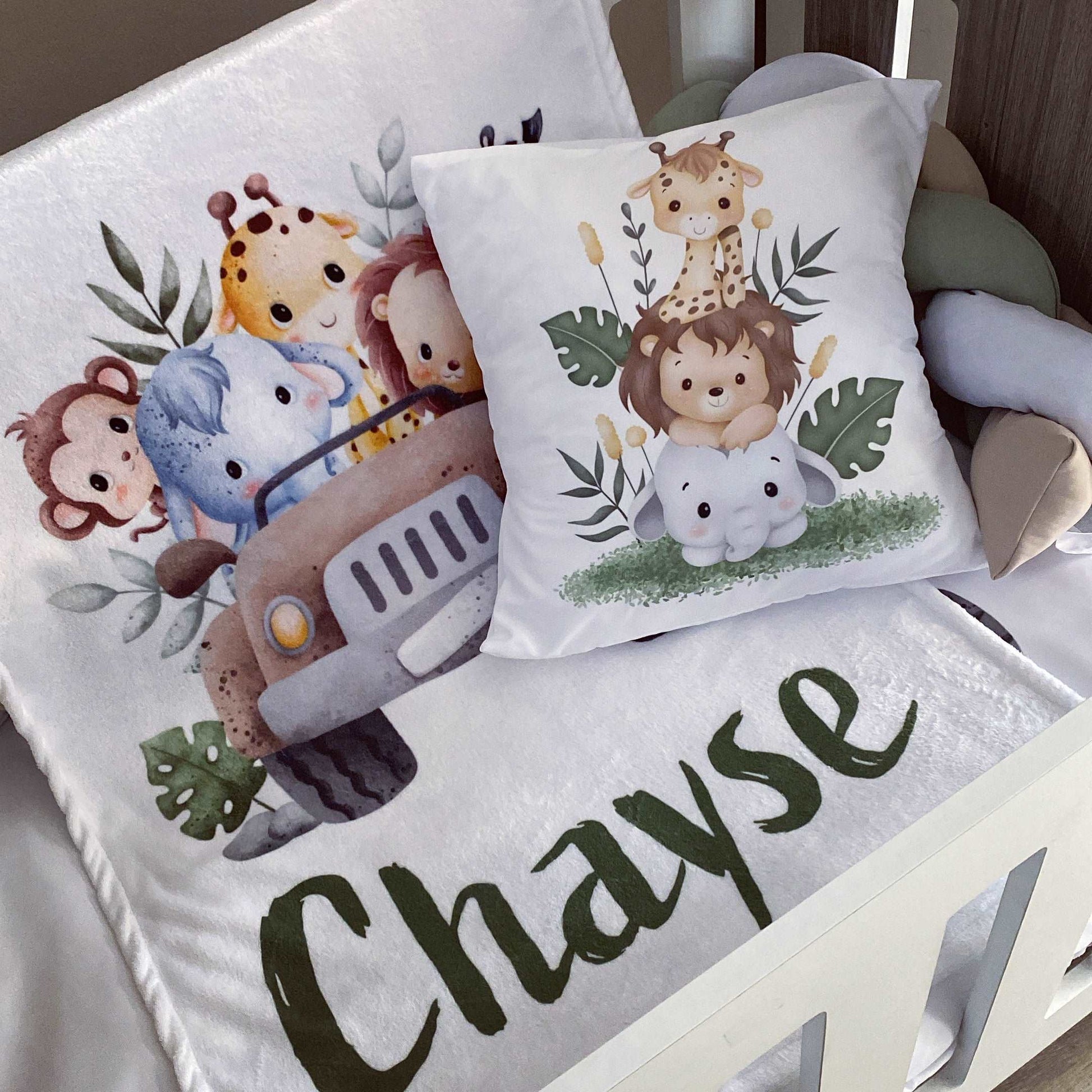 Children's pillow with cartoon animals and the name 'Chayse' on a white surface.