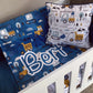 Children's bedding set with truck patterns and a pillow featuring construction vehicles on a crib. | Baby Essentials | All Baby Products | Soft Spot Kids | South Africa