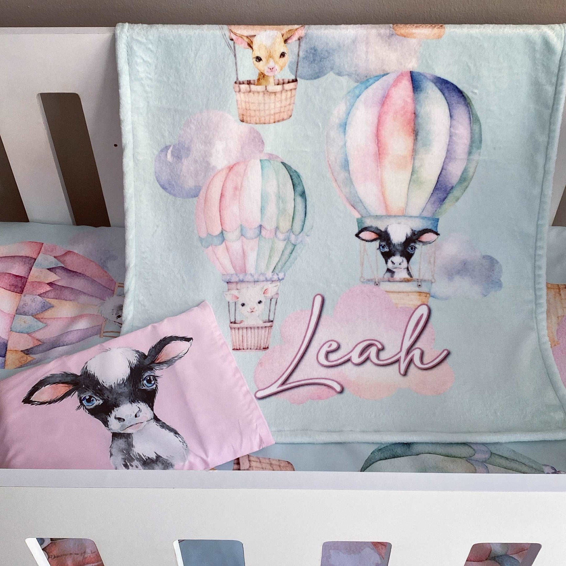 Children's bedding set with animal-themed design and 'Leah' text on a light blue background.