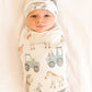 Newborn baby wrapped in a swaddle with farm animal prints and wearing a matching hat. | Baby Essentials | All Baby Products | Soft Spot Kids | South Africa