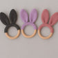 Three crocheted bunny ear teething rings in black, purple, and pink on a gray background. | Baby Essentials | All Baby Products | Soft Spot Kids | South Africa