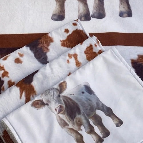 Fabric with cow print and calf illustration on a white background