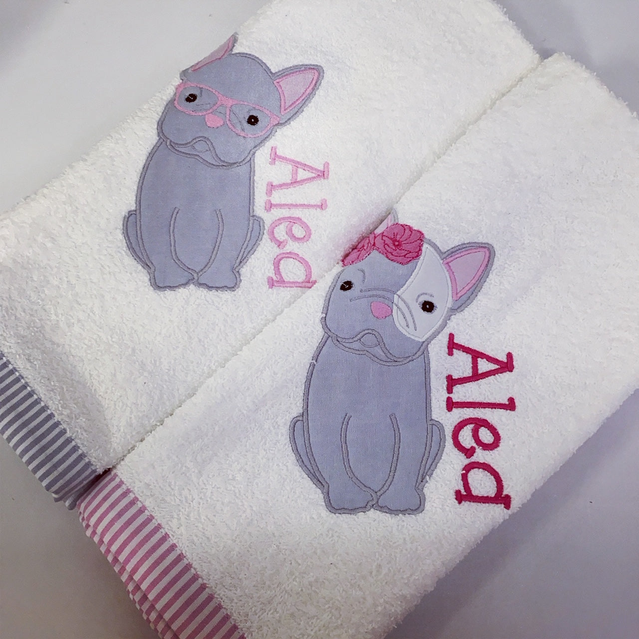 WhiteBurpcloths - Dog 01 with embroidered gray dog designs and 'Aled' text on a white background