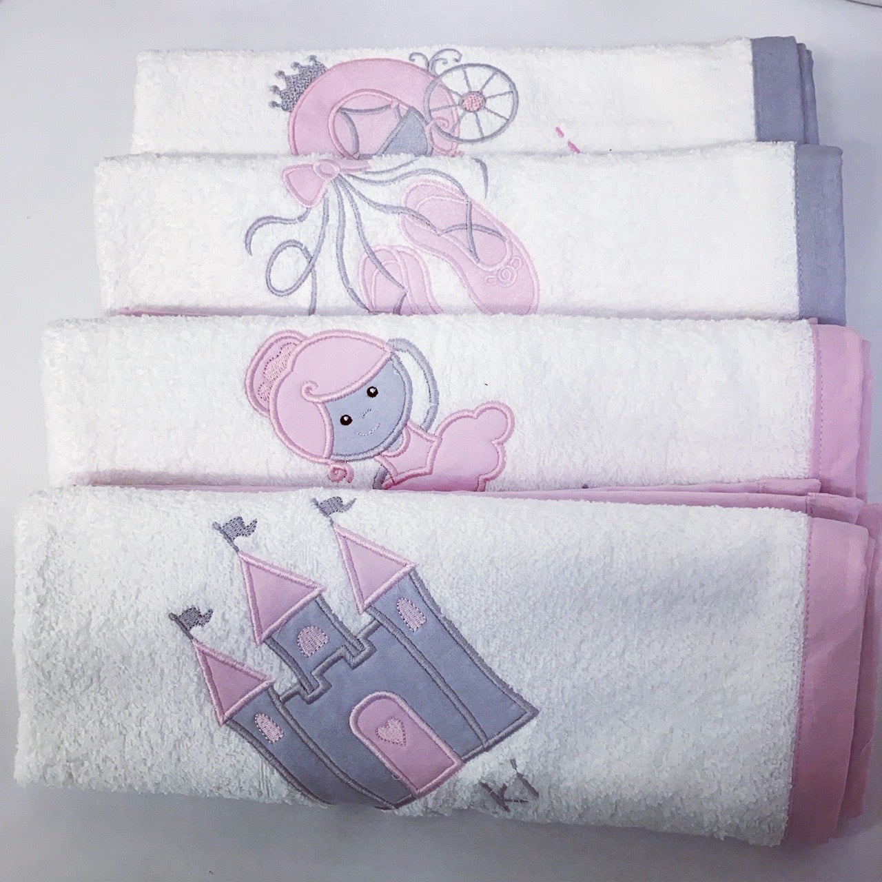 Set of three towels with princess-themed designs on a white background