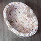 Floral-patterned baby carry cot on a wooden floor | Baby Carry Cots | Portable Baby Beds | Soft Spot Kids | South Africa