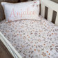 A cot with floral bedding and a pillowcase that has the name 'Anjalee' printed on it. | All Nursery Sets | Baby Bedding Sets South Africa | Soft Spot Kids | South Africa