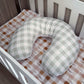 Green and white checkered U-shaped pillow on a crib with a patterned sheet. | All Nursery Sets | Baby Bedding Sets South Africa | Soft Spot Kids | South Africa