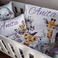 Custom safari-themed crib bedding set in a white wooden crib, featuring a duvet cover and matching pillowcases with watercolor illustrations of an elephant, giraffe, lion cub, and zebra, personalized with the name 'Anita' in purple script. | All Nursery Sets | Baby Bedding Sets South Africa | Soft Spot Kids | South Africa