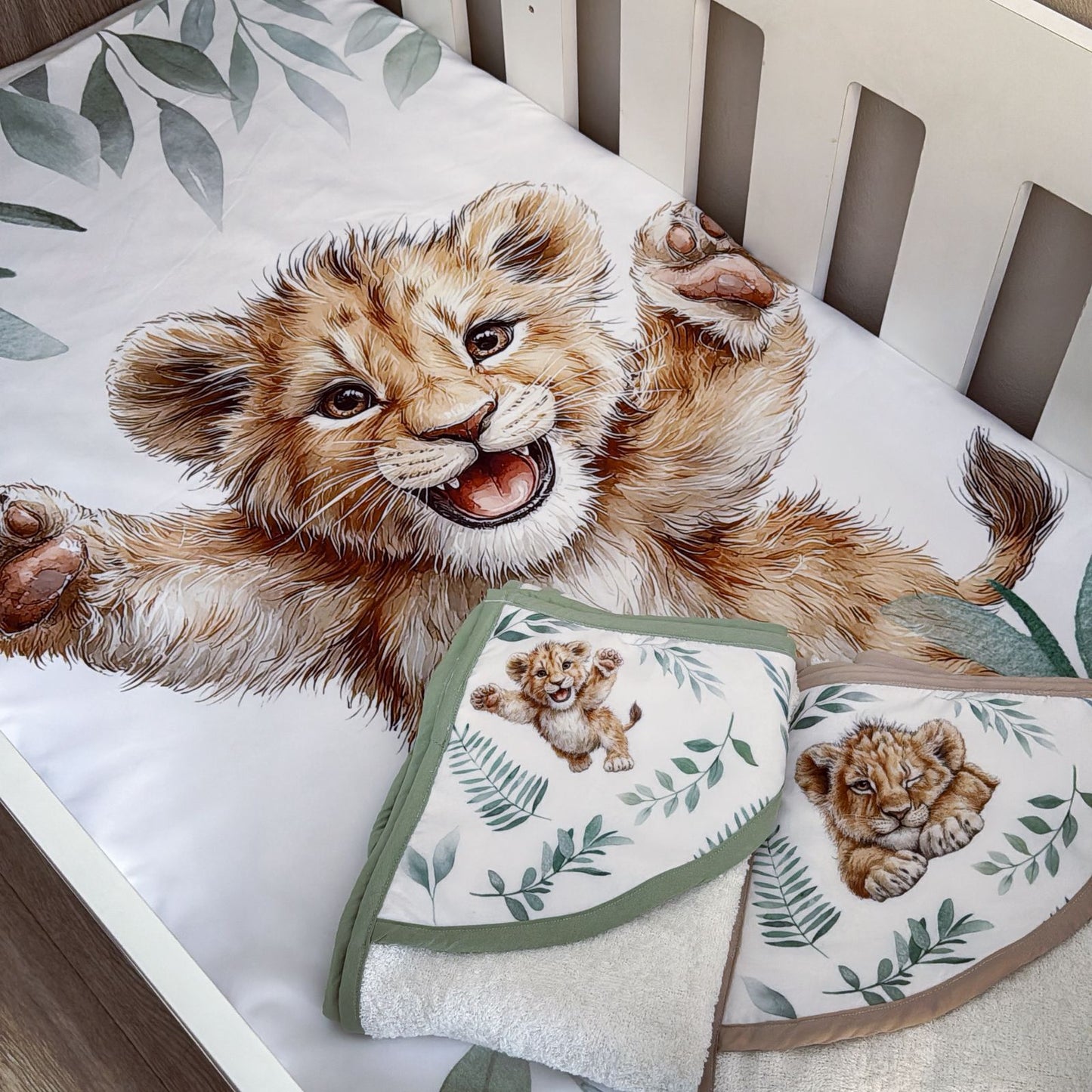 Crib set with lion cub design on a white crib