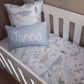 A baby bedding set in a white crib, featuring a white duvet cover and pillowcase with a blue-gray sea life print, and a light blue rectangular pillow with the name 'Janco' printed in white. | All Nursery Sets | Baby Bedding Sets South Africa | Soft Spot Kids | South Africa