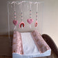 Baby crib with pink and rainbow-patterned bedding and mobile above. | All Nursery Sets | Baby Bedding Sets South Africa | Soft Spot Kids | South Africa
