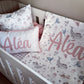 A personalized baby bedding set in a white wooden crib, featuring a whale and jellyfish print with the name 'Aléa' printed in pink on two pillows. | All Nursery Sets | Baby Bedding Sets South Africa | Soft Spot Kids | South Africa