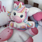 Colorful unicorn plush toy among other soft toys on a white surface | All Nursery Sets | Baby Bedding Sets South Africa | Soft Spot Kids | South Africa