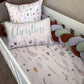 Crib with floral-patterned bedding and pillows, including a pillow with the name 'Christine'. | All Nursery Sets | Baby Bedding Sets South Africa | Soft Spot Kids | South Africa