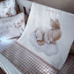 A baby bedding set featuring a white blanket with a sleeping bunny illustration and the text 'Jeremiah 29:11', a matching pillow with bunny graphics and text, and a pink-and-white gingham check blanket draped over a crib. | All Nursery Sets | Baby Bedding Sets South Africa | Soft Spot Kids | South Africa
