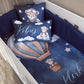 Custom baby bedding set in a crib, featuring a dark blue space-themed print with a teddy bear pilot in a hot air balloon, clouds, stars, and personalized names 'Kobus' and 'Kler' in white script. | All Nursery Sets | Baby Bedding Sets South Africa | Soft Spot Kids | South Africa