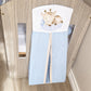 A baby crib nappy holder with a light blue body and a white top panel featuring a cartoon sleeping giraffe, shown draped over a wooden crib. | All Nursery Sets | Baby Bedding Sets South Africa | Soft Spot Kids | South Africa