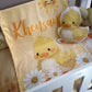 Baby blanket with duck design and 'Khensan' text, accompanied by a matching plush toy, on a crib. | All Nursery Sets | Baby Bedding Sets South Africa | Soft Spot Kids | South Africa