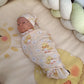 Newborn baby swaddled in a blanket with duck patterns on a soft surface. | All Nursery Sets | Baby Bedding Sets South Africa | Soft Spot Kids | South Africa
