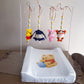 Baby crib mobile with cartoon characters above a changing table with a similar design. | All Nursery Sets | Baby Bedding Sets South Africa | Soft Spot Kids | South Africa