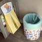 Children's toy storage bin with cartoon design on a wooden floor. | All Nursery Sets | Baby Bedding Sets South Africa | Soft Spot Kids | South Africa