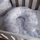 A U-shaped baby support pillow with matching crib bedding featuring a light blue and beige whale, turtle, and seashell pattern, shown inside a white wooden crib. | All Nursery Sets | Baby Bedding Sets South Africa | Soft Spot Kids | South Africa