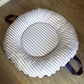 Round cushion with striped pattern on a wooden floor | Baby Doughnut Cushions | Infant Support Pillows | Soft Spot Kids | South Africa