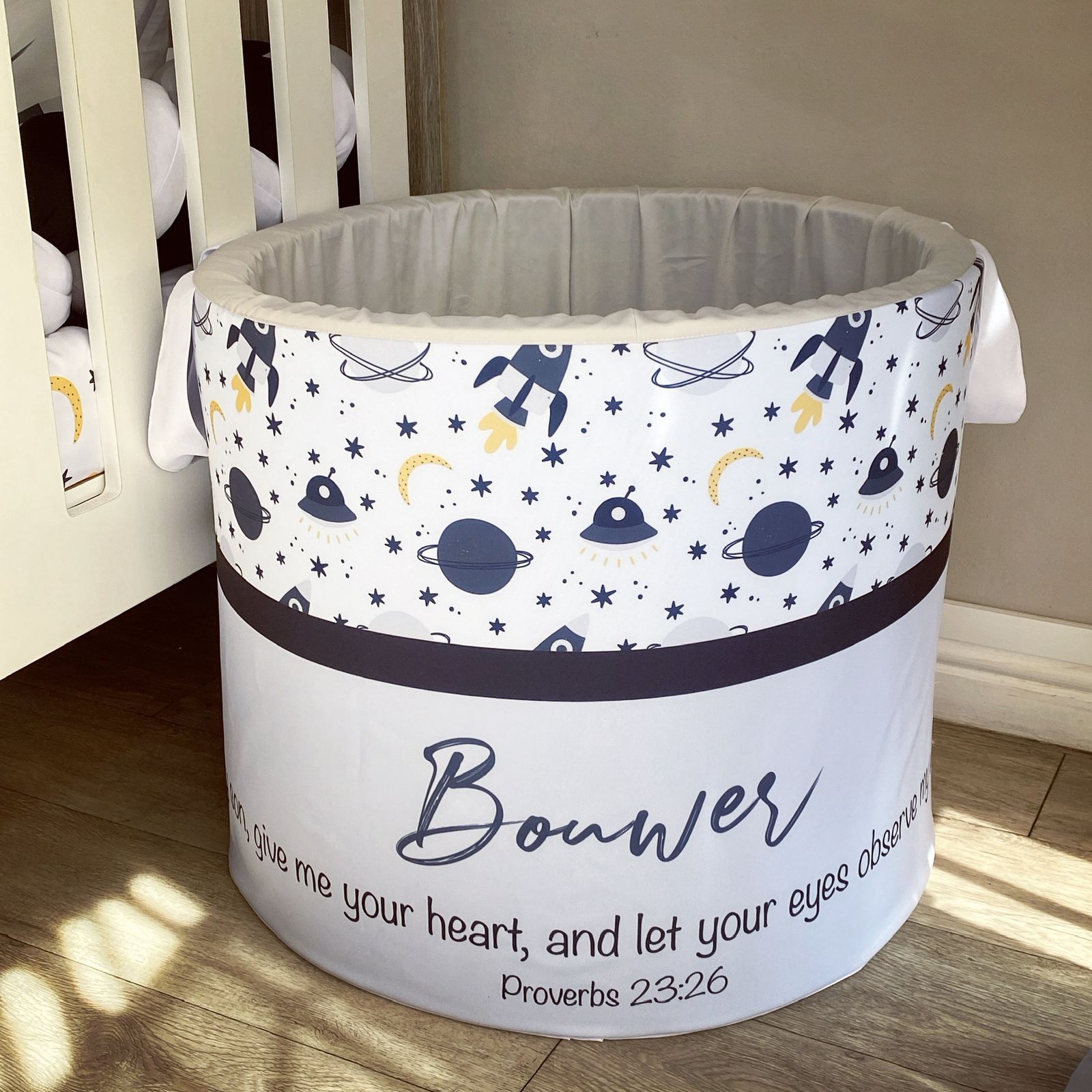 Children's storage bin with space-themed design and 'Bower' branding.