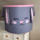 A large laundry basket with a cartoon bunny face design, predominantly gray with pink inner ears and a smiling face. | Baby Essentials | All Baby Products | Soft Spot Kids | South Africa