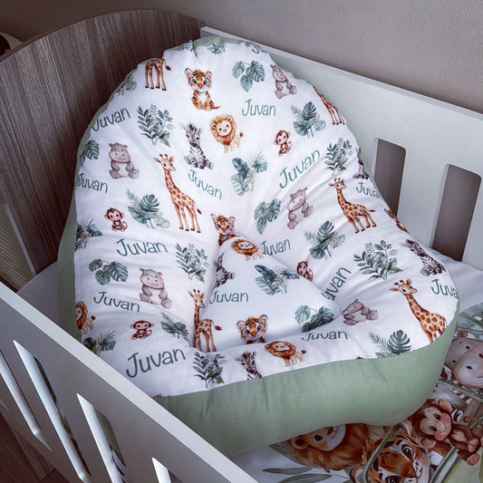 Crib with a white comforter featuring animal prints and the brand 'Juwan'.