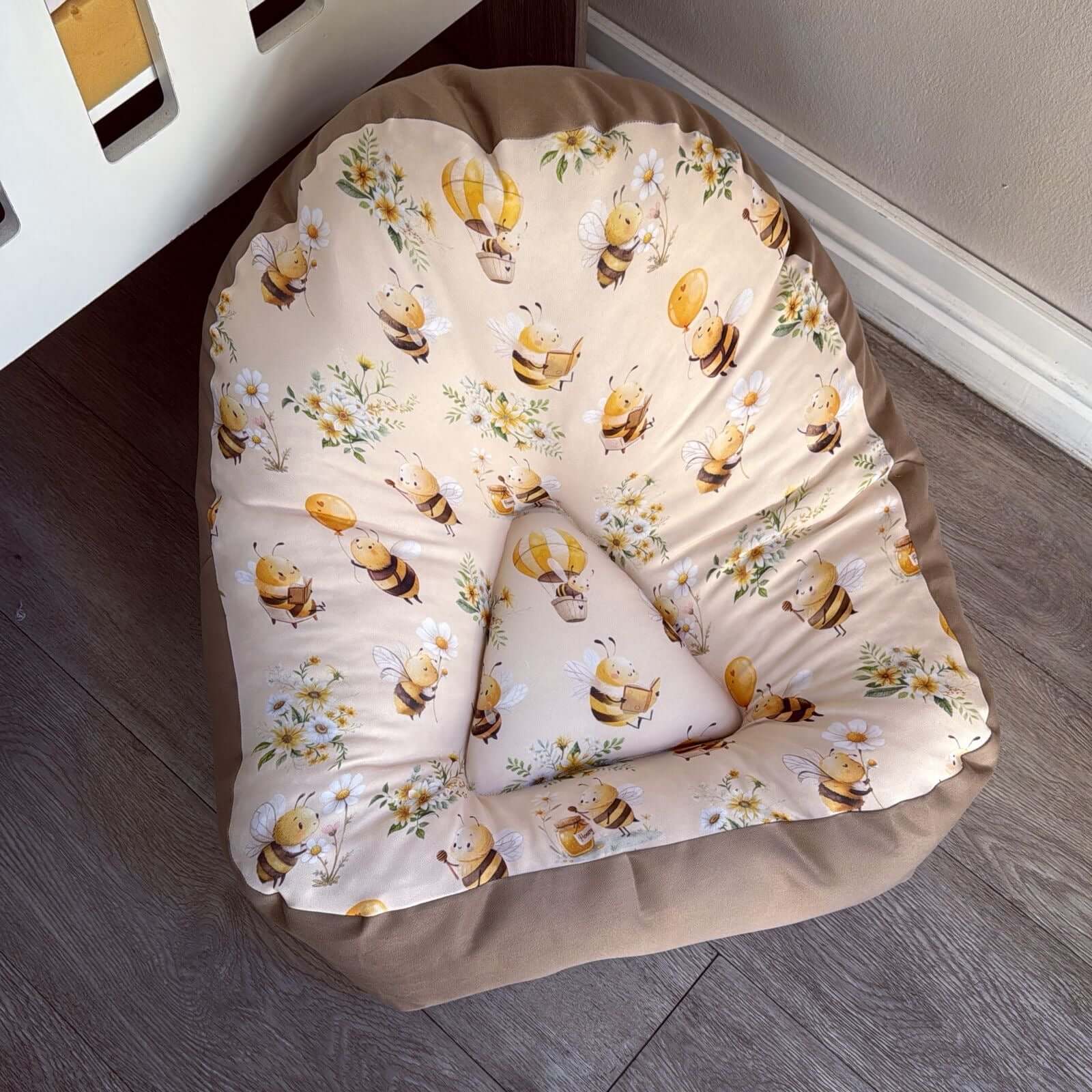 Lounger - Yellow Bee 01 chair with bee and flower pattern on a wooden floor.