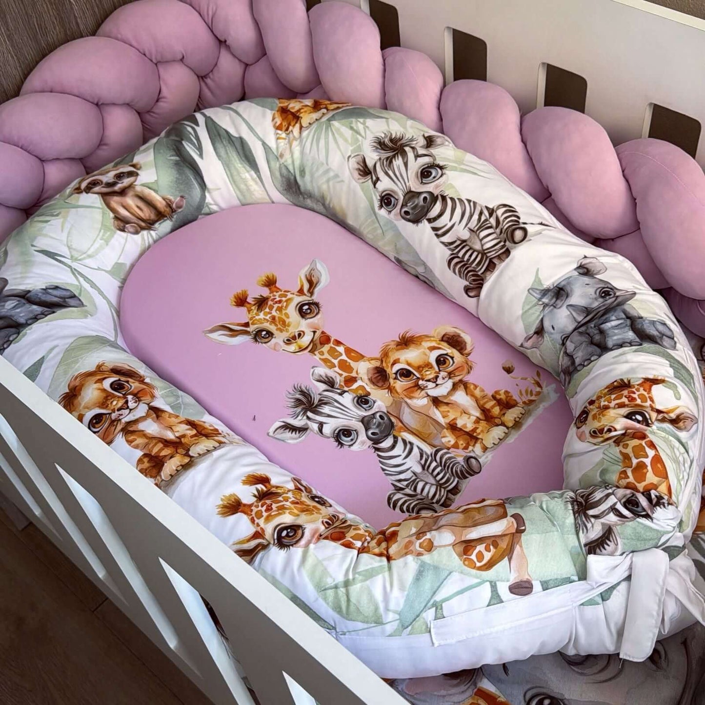 Baby crib bumper with animal pattern in a crib