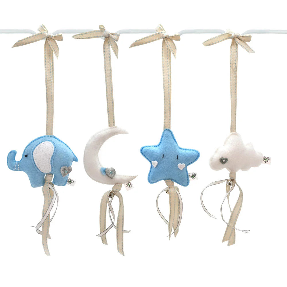 A set of four baby nursery hanging ornaments on a white cord, featuring a blue elephant, a cream crescent moon, a blue star, and a white cloud, each with a cream ribbon bow and dangling ribbon tails.