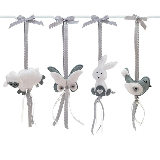 A set of four soft fabric nursery hanging ornaments on a white rod, including a sheep, butterfly, bunny, and bird, in white, gray, and dark gray colors.