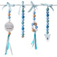 A set of four beaded baby teething rings hanging from a metal rod with light blue ribbons. The rings feature pastel blue, mint green, white, and natural wood beads, with one ring decorated with a round wooden disc that reads 'WILD heart' and another with a koala head charm. | Baby Essentials | All Baby Products | Soft Spot Kids | South Africa