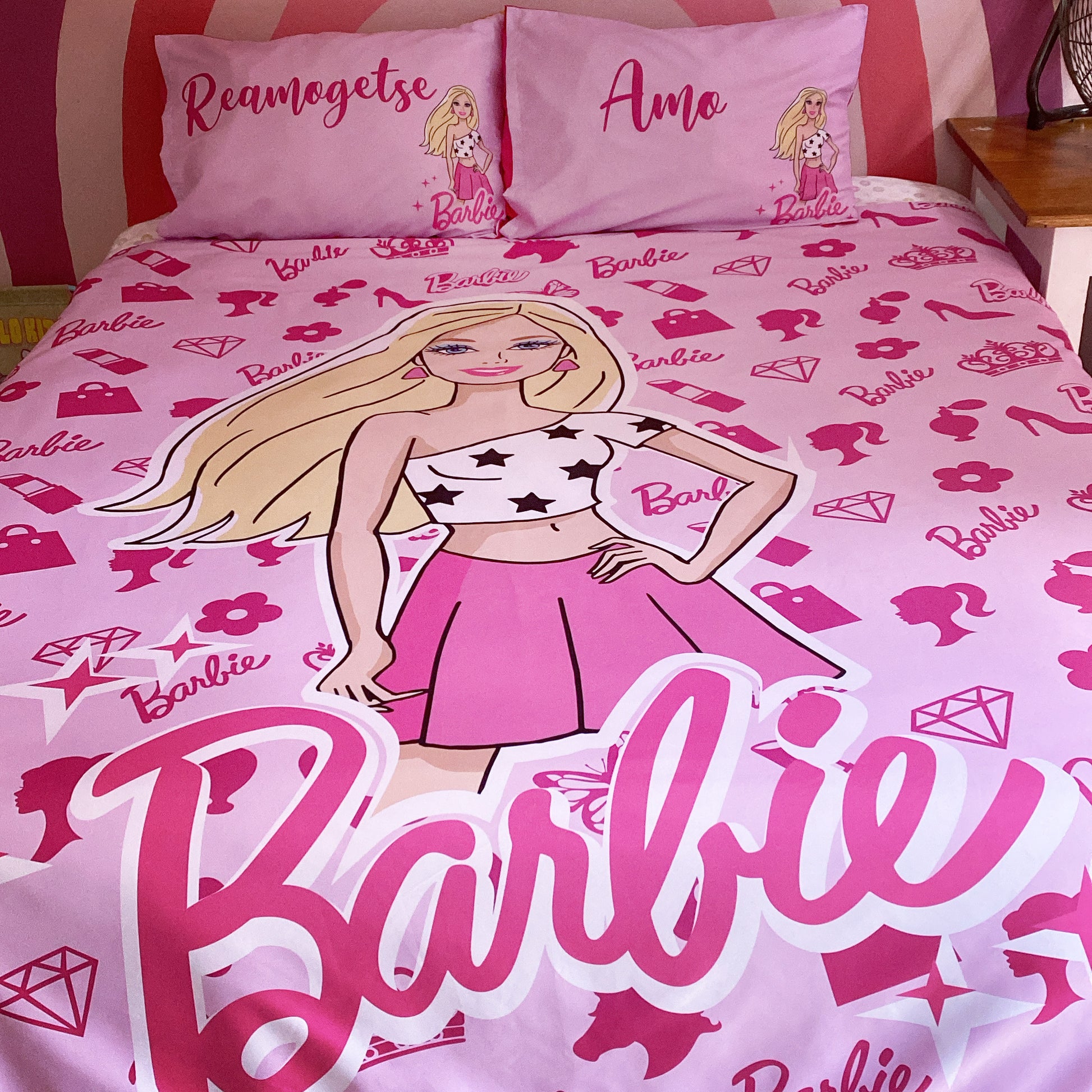 Barbie-themed bedding set with character and text on a pink background