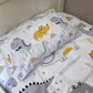 Children's dinosaur-themed pillowcase and sheet set on a bed. | Baby Essentials | All Baby Products | Soft Spot Kids | South Africa
