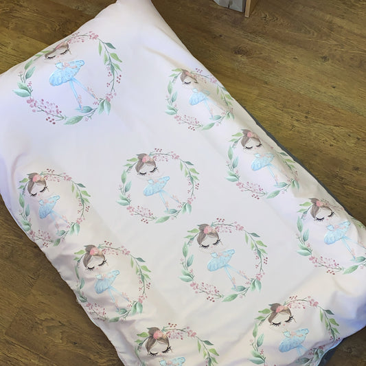 Floral and butterfly patterned fabric on a wooden surface