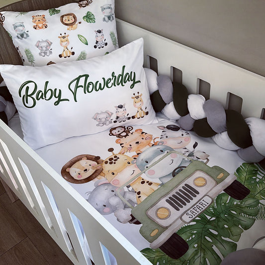 Crib with safari-themed bedding, pillows, and bumper